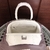 Balenciaga Frame Hourglass Small Bag with Crocodile Texture in White: An elegant handbag with crocodile texture in white, ideal for a sophisticated and modern look.