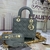 Bolsa Lady Dior Small Cannage Lambskin Gray: Bolsa elegante em couro cinza, com o distintivo padrão cannage da Dior, perfeita para um visual sofisticado e contemporâneo.