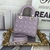 Bolsa Lady Dior Small Cannage Lambskin Light Purple: Bolsa de luxo em couro de cor lilás claro com o icônico padrão cannage da Dior, adicionando um toque de elegância e sofisticação ao seu visual.