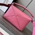 Loewe Small Puzzle Grained Calfskin Bag in Pink: A small Loewe Puzzle bag in pink grained leather, adding a touch of delicacy and elegance to the look.