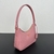 Mini Bolso Prada en Piel Saffiano Rosa: Un mini bolso de Prada en piel saffiano rosa, elegante y delicado para complementar tu look con un toque femenino.