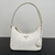 Prada Mini Bag in White Saffiano Leather": A mini bag from Prada in white saffiano leather, perfect for adding a touch of elegance and sophistication to your look.