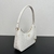 Mini Bolso Prada en Piel Saffiano Blanca": Un mini bolso de Prada en piel saffiano blanca, perfecto para añadir un toque de elegancia y sofisticación a tu look.