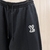 Calça Louis Vuitton x Nigo LV Noir "Black": Calça preta da colaboração Louis Vuitton x Nigo, para um estilo urbano contemporâneo e sofisticado.