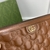 Gucci Calfskin GG Matelasse Brown Clutch: A luxury Gucci clutch in quilted calfskin with GG pattern in shades of brown, perfect for adding a touch of elegance to any look.