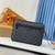 Louis Vuitton "Damier Graphite" Clutch: An elegant handbag in a Damier Graphite pattern, perfect for a modern and refined look.