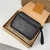 Louis Vuitton "Damier Graphite" Clutch: An elegant handbag in a Damier Graphite pattern, perfect for a modern and refined look.