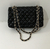 Chanel Double Flap Bag "Black": An elegant Chanel bag in classic black, with the iconic double flap closure, chain strap and interwoven leather, ideal for a sophisticated and timeless look.