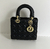 Bolsa Lady Dior Small Black": Uma elegante bolsa preta da Dior, conhecida por seu design icônico e detalhes de costura cannage, perfeita para um look sofisticado e atemporal.