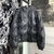 This standout jacket is made from soft lambskin and quilted with certified down feathers. Monogram signatures are hot stamped into the leather, creating an upholstery effect with deep buttons. This piece has a hood with integrated visor and high collar, c