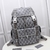 Dior Hit The Road Large CD Diamond Canvas Gray Backpack: An elegant Dior backpack in gray canvas with the iconic CD Diamond pattern, perfect for those looking for style and practicality in their accessories.