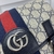 Gucci Ophidia Medium Backpack in GG Canvas Beige and Dark Blue: A sophisticated backpack with leather details and Gucci's emblematic GG pattern, ideal for a modern and refined look.