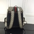 Mochila mediana Gucci Ophidia en lona GG Beige y ébano: una mochila de lujo con detalles de cuero y el icónico patrón GG de Gucci, perfecta para un estilo elegante y casual.