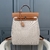 Hermes Backpack in Toile and Natural Calf Leather Beige and Brown: A stylish backpack from Hermes, featuring a sophisticated design in neutral tones, ideal for a chic urban style.