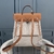 Mochila Hermes em Toile e Couro de Bezerro Natural Bege e Marrom: Uma mochila elegante da Hermes, apresentando um design sofisticado em tons neutros, ideal para um estilo urbano chique.