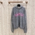 Gucci GG Wool Hoodie "Gray/Pink": A gray Gucci GG fleece print sweatshirt in shades of gray and pink for a modern, stylish look.