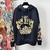 Versace Seashell Baroque Black Sweatshirt: Black sweatshirt with baroque seashell pattern from Versace, adding a touch of sophistication and luxurious style to the casual look.