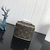 A Louis Vuitton Nano Toiletry Pouch toiletry bag with the brand's Monogram Canvas pattern. This small accessory is perfect for storing personal hygiene items in a compact and elegant way. With its classic and durable design, it is a practical and stylish 