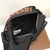 A Burberry fanny pack with the brand's distinctive Horseferry pattern, featuring a black and orange color combination. This fanny pack is practical and stylish, perfect for storing essential items with ease and elegance. With a modern and vibrant design, 