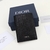 Dior Two-Fold Oblique Black Card Holder: A luxurious folding card holder from Dior in elegant black with an oblique pattern, ideal for storing your cards in style.