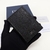 Dior Two-Fold Oblique Black Card Holder: A luxurious folding card holder from Dior in elegant black with an oblique pattern, ideal for storing your cards in style.