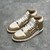 Amiri Skel Top Hi "Brown/White" Sneakers: Brown high shoes with white details, modern design from the Amiri brand.