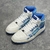 Amiri Skel Top Hi "White/Light Blue" Sneakers: White high shoes with light blue details, modern design from the Amiri brand.