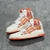 Amiri Skel Top Hi "White/Orange" Sneakers: White high shoes with orange details, modern design from the Amiri brand.