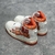 Tênis Amiri Skel Top Hi "White/Orange": Calçado alto em branco com detalhes em laranja, design moderno da marca Amiri.