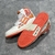 Amiri Skel Top Hi "White/Orange" Sneakers: White high shoes with orange details, modern design from the Amiri brand.