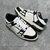 Amiri Skel Top Low "White/Black" Sneakers: White low shoes with black details, modern design from the Amiri brand.