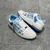 Amiri Skel Top Low "White/Light Blue" Sneakers: White low shoes with light blue details, modern design from the Amiri brand.