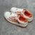 Amiri Skel Top Low "White/Orange" Sneakers: White low shoes with orange details, modern design from the Amiri brand.