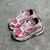 Pink/White Balenciaga Runner Sneakers: A pair of Balenciaga sneakers with a predominance of pink and white details, creating a modern and feminine style.