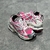 Pink/White Balenciaga Runner Sneakers: A pair of Balenciaga sneakers with a predominance of pink and white details, creating a modern and feminine style.