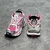 Pink/White Balenciaga Runner Sneakers: A pair of Balenciaga sneakers with a predominance of pink and white details, creating a modern and feminine style.