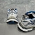 Balenciaga Runner Silver/Blue Sneakers: Features an elegant design with blue details on a silver background, ideal for those looking for a modern and sophisticated look.