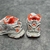 Balenciaga Runner White/Orange Sneakers: A pair of Balenciaga sneakers with orange details on a white background, perfect for a sporty and modern look.