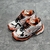 Balenciaga Runner White/Orange/Black Sneakers: A pair of Balenciaga sneakers with a white, orange and black color combination, designed for a sporty and modern style.