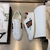 Gucci Band Ace White Sneakers: A pair of white sneakers with details of Gucci's iconic green and red stripe, showcasing sophistication and timeless style.