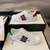 Gucci Band Ace White Sneakers: A pair of white sneakers with details of Gucci's iconic green and red stripe, showcasing sophistication and timeless style.