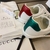 Gucci Band Ace White Sneakers: A pair of white sneakers with details of Gucci's iconic green and red stripe, showcasing sophistication and timeless style.