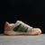 Gucci Screener GG Beige/Green Sneakers: A pair of sneakers with green accents on a beige background, evoking a modern urban style with a retro vibe.