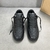 Tênis Louis Vuitton x Nike Air Force 1 Low By Virgil Abloh All Black: Um par de tênis totalmente pretos, parte da colaboração entre Louis Vuitton e Nike, desenhado por Virgil Abloh.