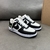 Louis Vuitton x Nike Air Force 1 Low By Virgil Abloh Black/White Sneakers: A pair of black and white sneakers, part of the collaboration between Louis Vuitton and Nike, created by Virgil Abloh.