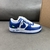 Louis Vuitton x Nike Air Force 1 Low By Virgil Abloh Blue/White Sneakers: A pair of sneakers with a blue and white design, the result of a collaboration between Louis Vuitton and Nike, created by Virgil Abloh.