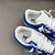 Louis Vuitton x Nike Air Force 1 Low By Virgil Abloh Blue/White Sneakers: A pair of sneakers with a blue and white design, the result of a collaboration between Louis Vuitton and Nike, created by Virgil Abloh.