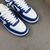 Tênis Louis Vuitton x Nike Air Force 1 Low By Virgil Abloh Blue/White: Um par de tênis com design em azul e branco, resultado da colaboração entre Louis Vuitton e Nike, criado por Virgil Abloh.