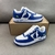 Tênis Louis Vuitton x Nike Air Force 1 Low By Virgil Abloh Blue/White: Um par de tênis com design em azul e branco, resultado da colaboração entre Louis Vuitton e Nike, criado por Virgil Abloh.