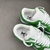 Louis Vuitton x Nike Air Force 1 Low By Virgil Abloh Green/White Sneakers: A pair of green and white sneakers, part of the collaboration between Louis Vuitton and Nike, created by Virgil Abloh.